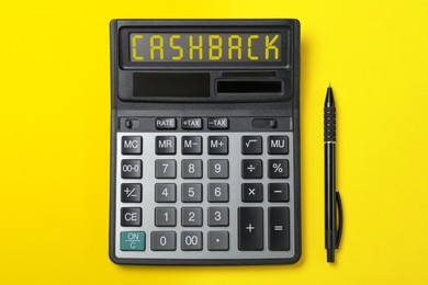 Image of Calculator with word Cashback and pen on yellow background, top view