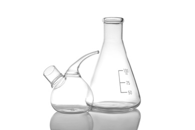 Photo of Empty retort and conical flasks on white background. Laboratory glassware