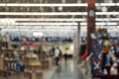 Blurred view of Christmas decorations in shopping mall. Bokeh effect