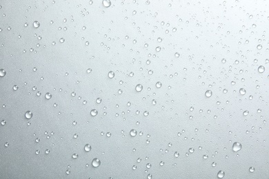 Photo of Many clean water drops on grey background