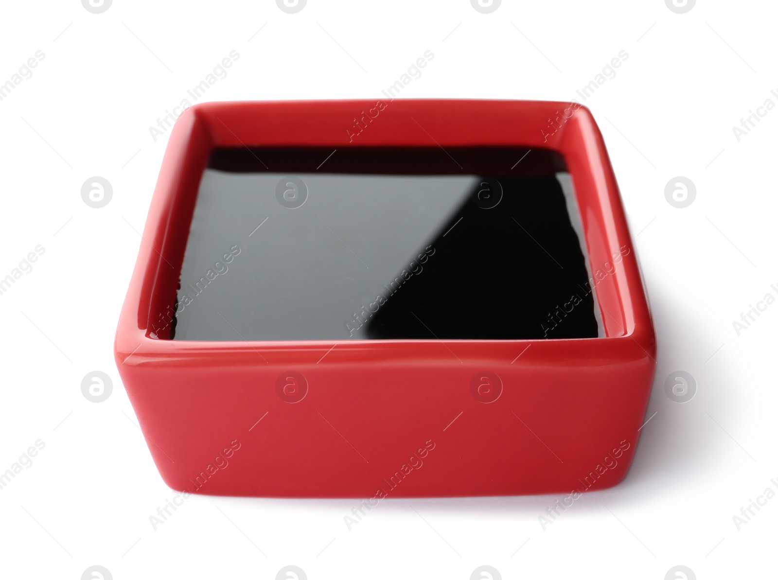 Photo of Dish of soy sauce on white background