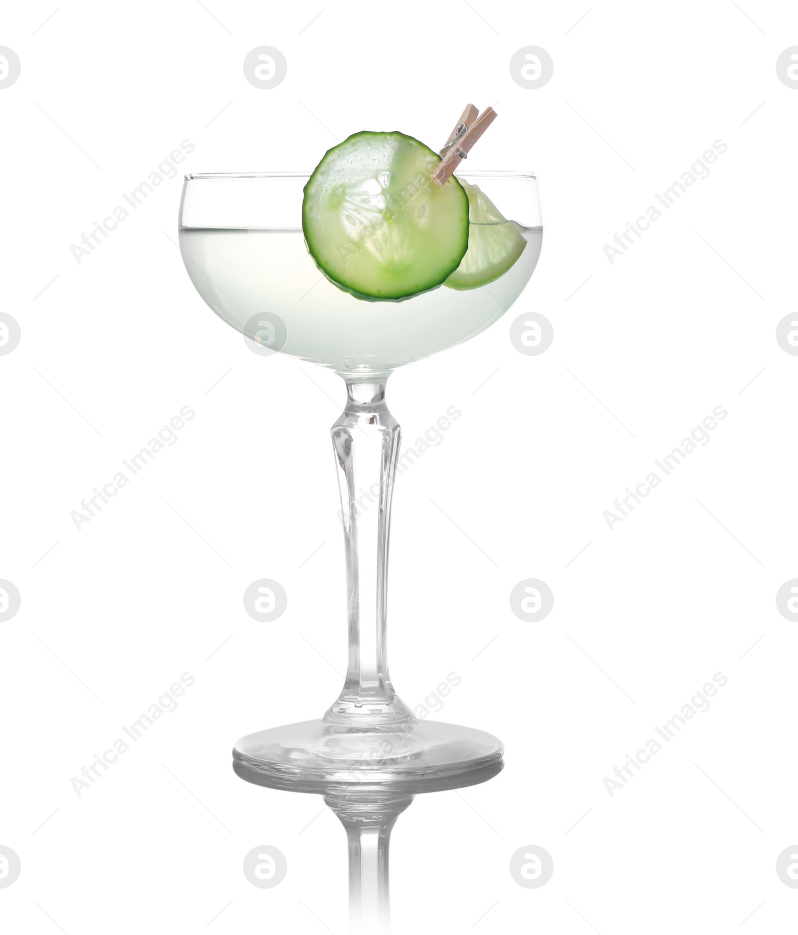 Photo of Glass of tasty martini with cucumber and lime on white background