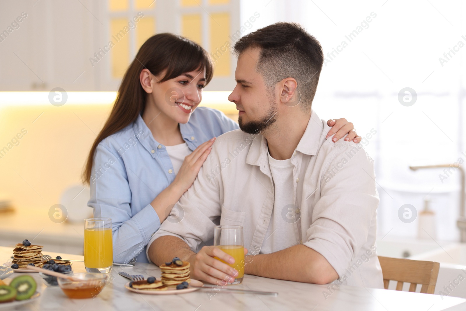 Photo of Happy couple spending time together during breakfast at home