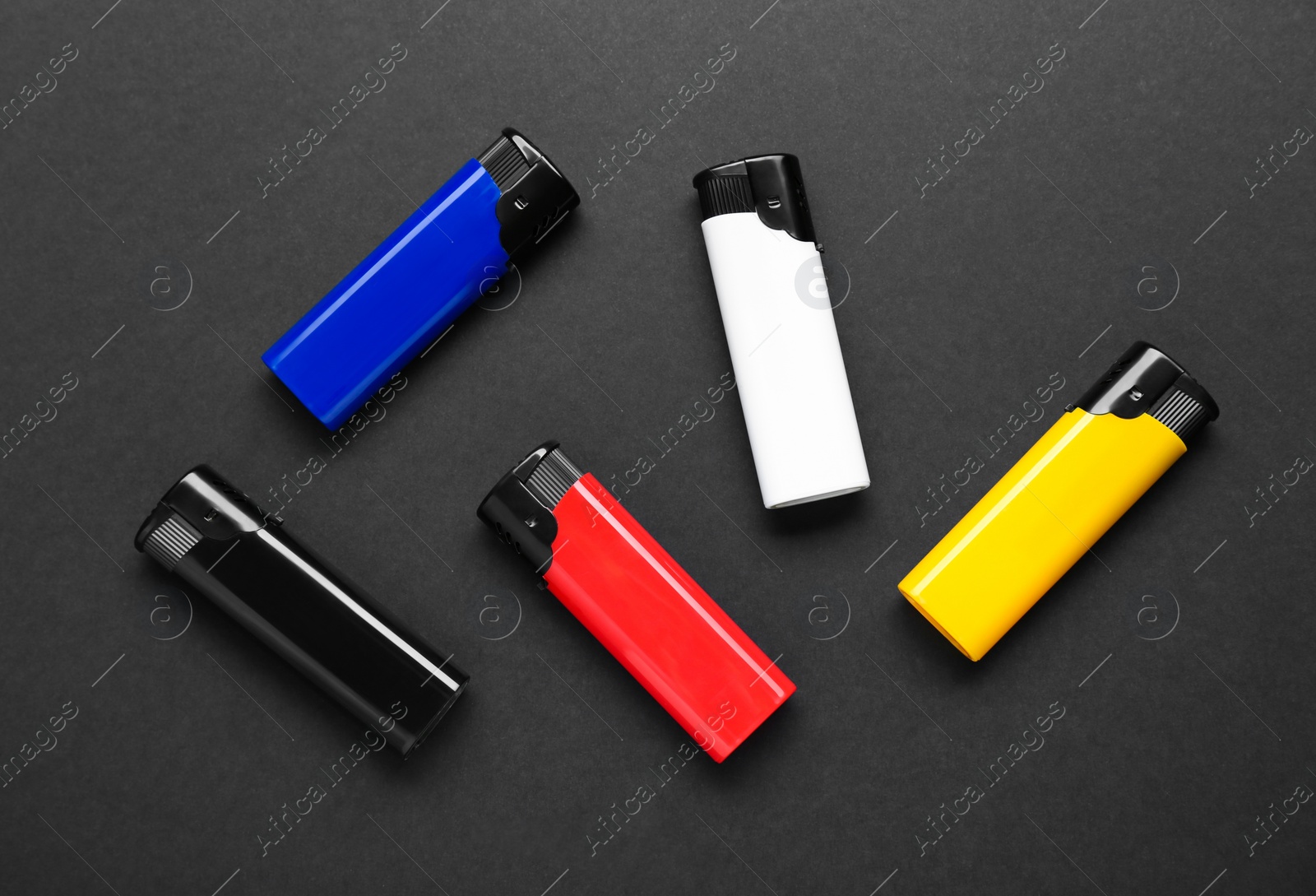 Photo of Stylish small pocket lighters on black background, flat lay