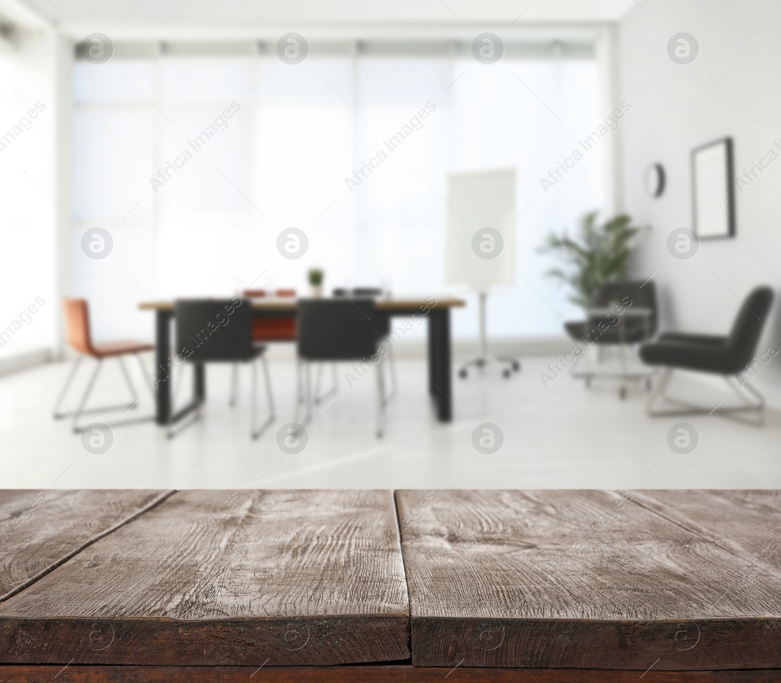 Image of Empty wooden surface and blurred view of modern office interior, closeup. Space for text 