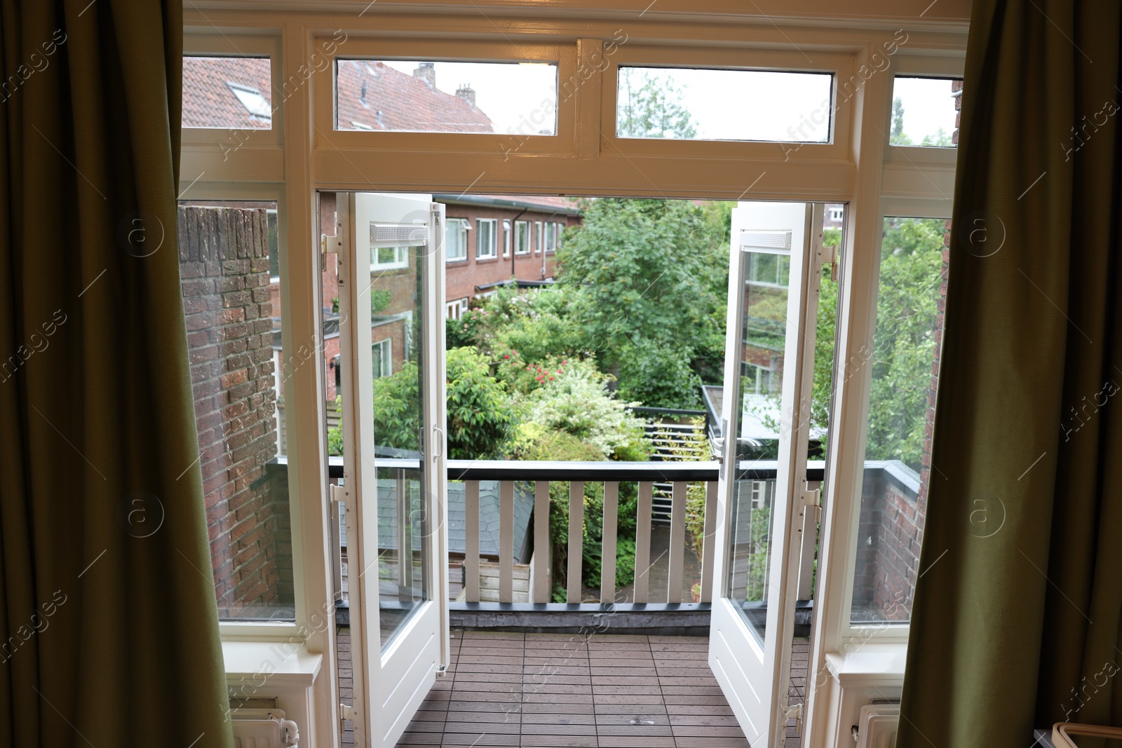 Photo of Beautiful view on balcony and inner yard with green trees from apartment