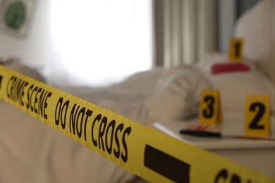 Crime scene in bedroom. focus on yellow tape