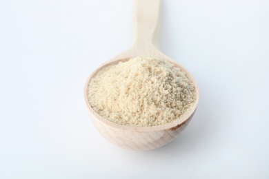 Photo of Spoon of sesame flour isolated on white