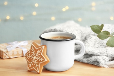 Composition with cup of hot winter drink and Christmas cookie on table. Cozy season