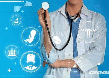 Doctor with stethoscope and different virtual icons on blue background. Reproductive medicine concept