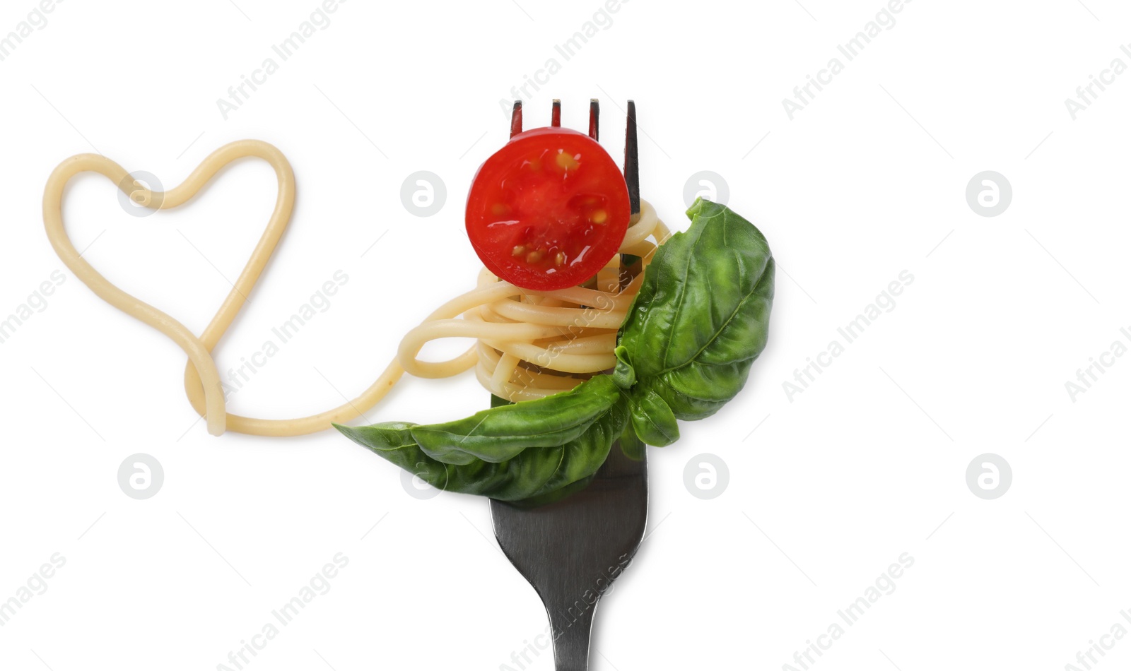 Photo of Heart made of tasty pasta, cut tomato and basil isolated on white