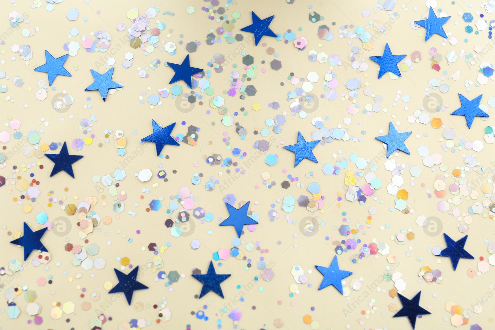 Photo of Shiny glitter on beige background, flat lay