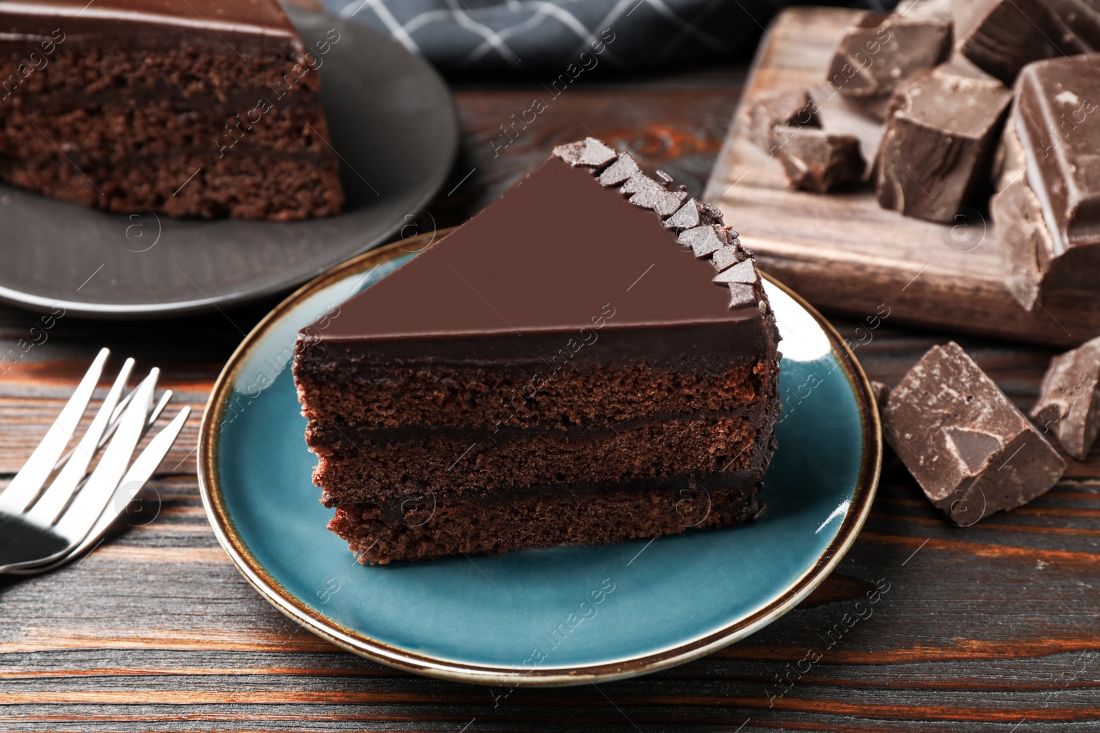 Photo of Piece of delicious chocolate cake on wooden table