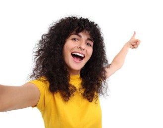 Photo of Beautiful young woman taking selfie on white background