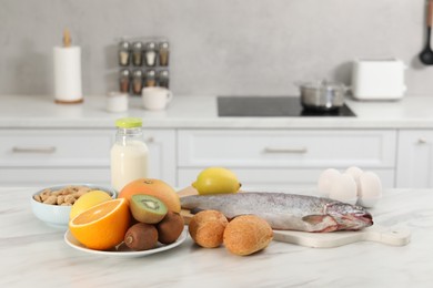 Allergenic food. Different fresh products on light marble table in kitchen