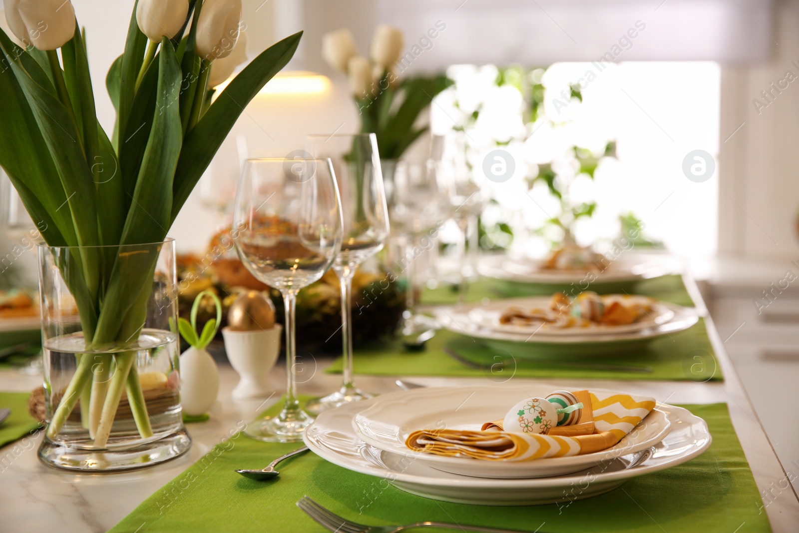 Photo of Festive Easter table setting with floral decor