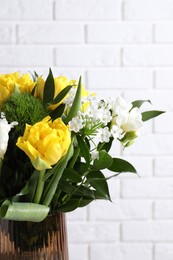 Photo of Beautiful bouquet with peony tulips near white brick wall, closeup