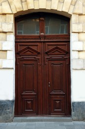 Photo of Entrance of house with beautiful wooden door and transom window
