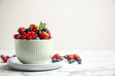 Photo of Mix of ripe berries on white marble table. Space for text