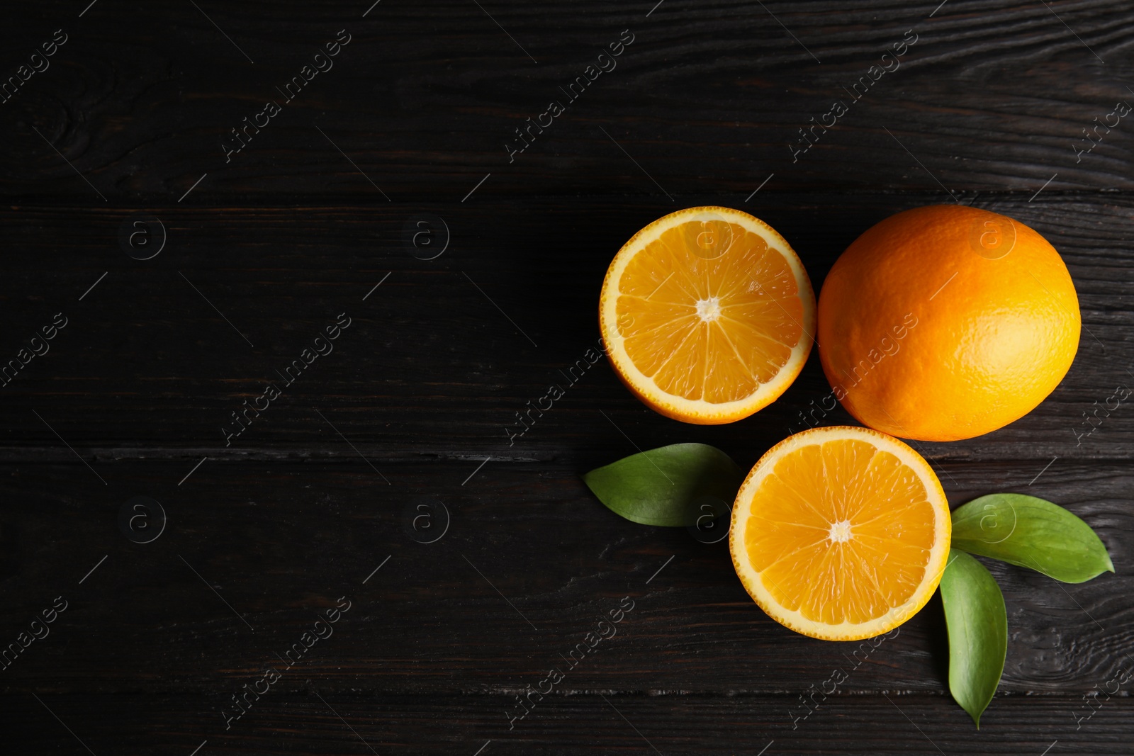 Photo of Flat lay composition with fresh oranges on wooden table. Space for text