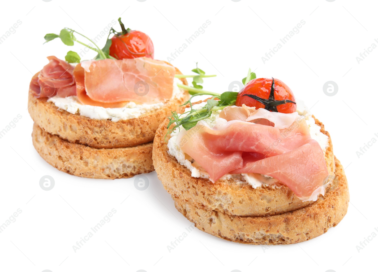 Photo of Tasty rusks with prosciutto, cream cheese and tomatoes on white background