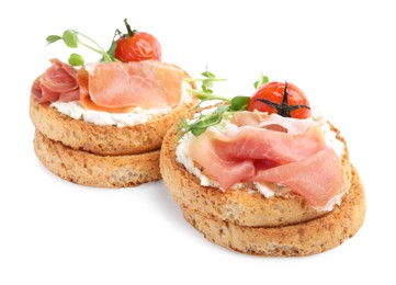 Photo of Tasty rusks with prosciutto, cream cheese and tomatoes on white background