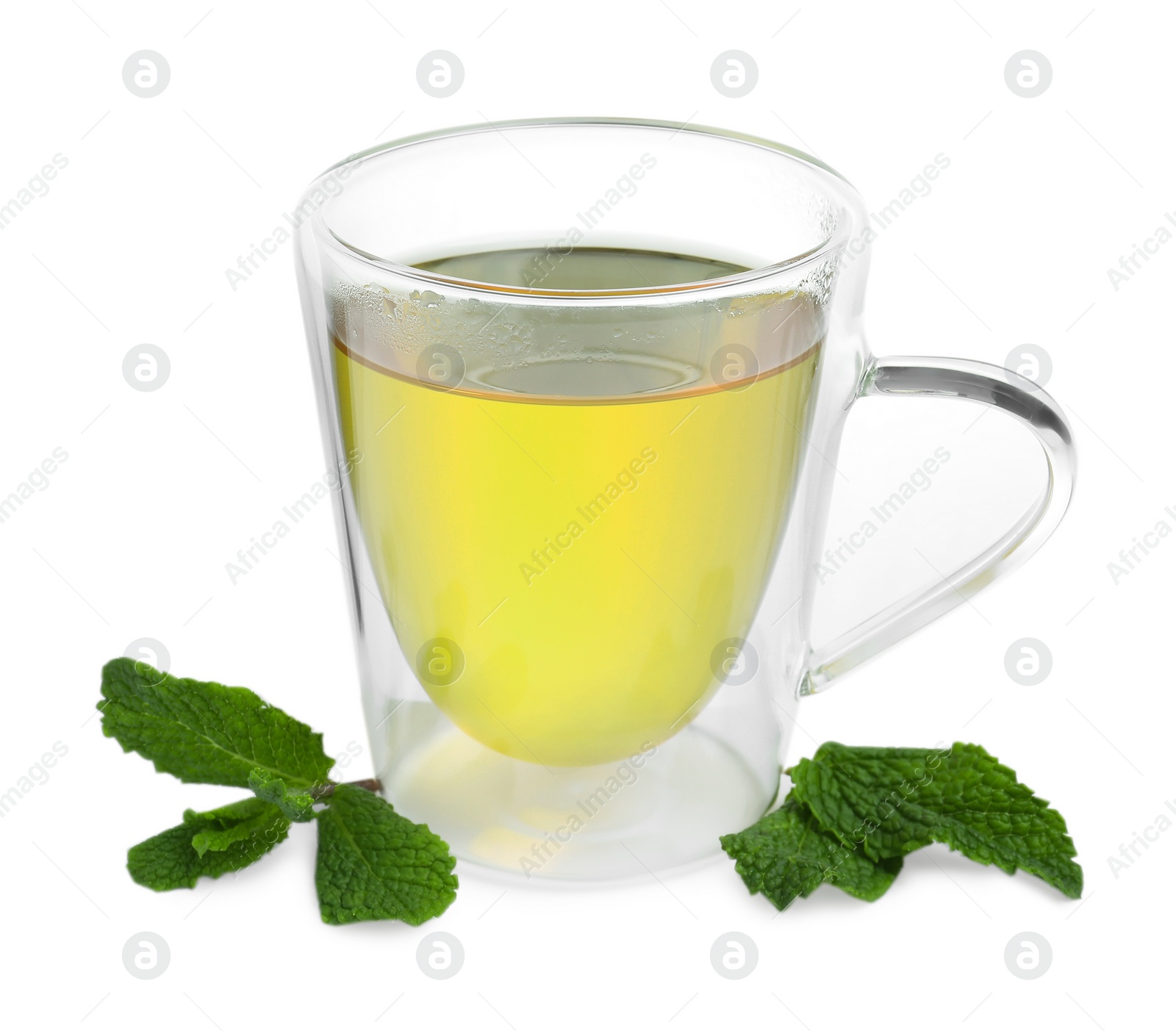 Photo of Fresh green tea in glass mug and mint isolated on white