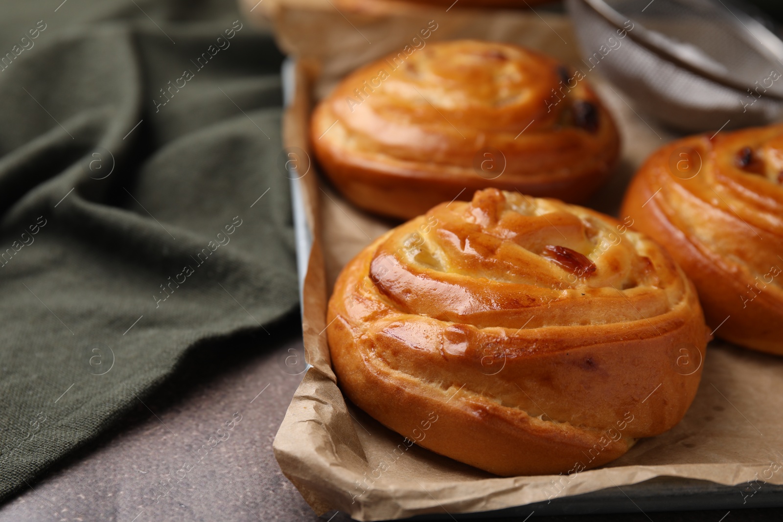 Photo of Sweet buns. Delicious rolls on brown textured table, closeup. Space for text