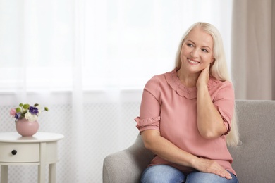 Portrait of beautiful older woman indoors with space for text