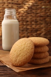 Delicious Danish butter cookies and milk on wooden table, closeup