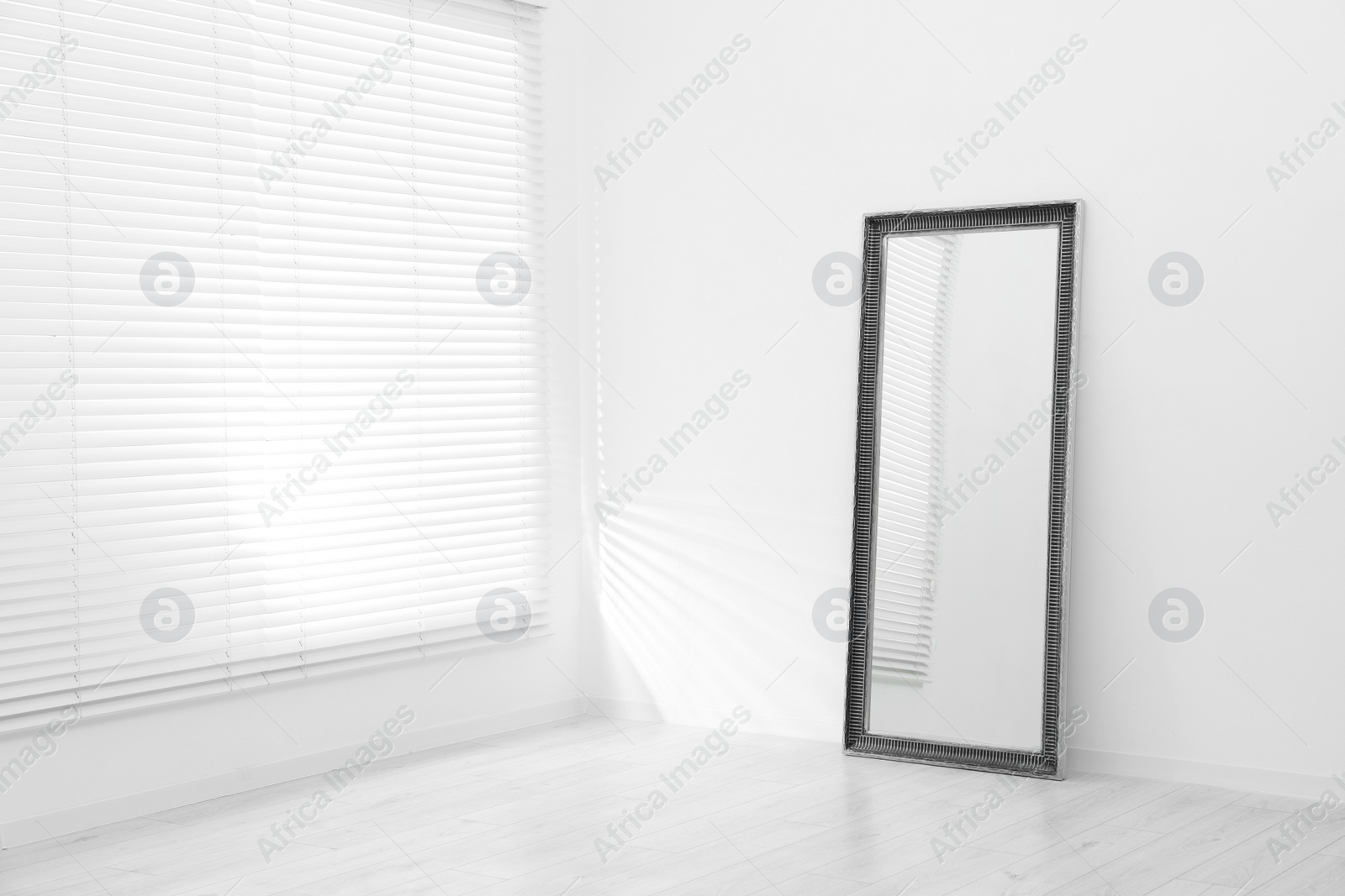 Photo of Stylish long mirror in makeup room. Space for text