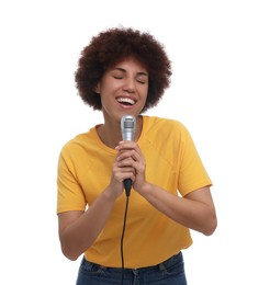 Curly young woman with microphone singing on white background