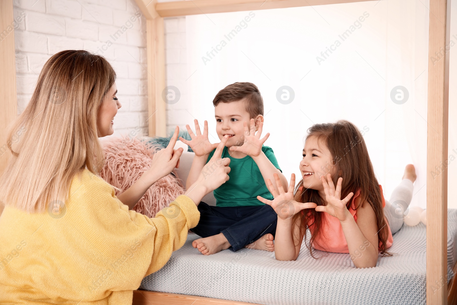 Photo of Nanny and little children playing at home