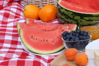 Picnic blanket with delicious food, closeup view