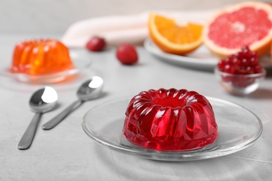 Photo of Delicious fresh red jelly on grey table