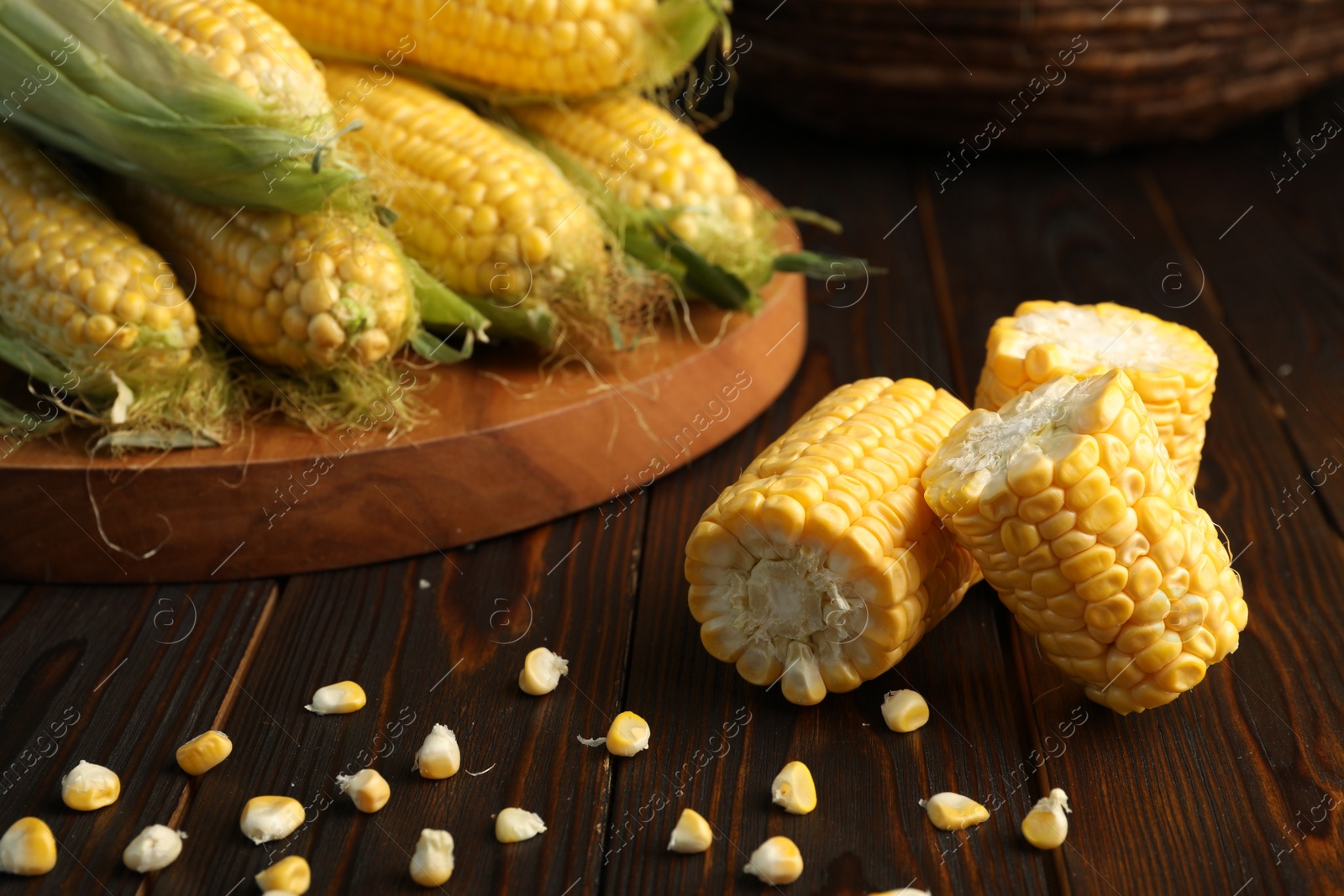 Photo of Tasty sweet corn cobs on wooden table