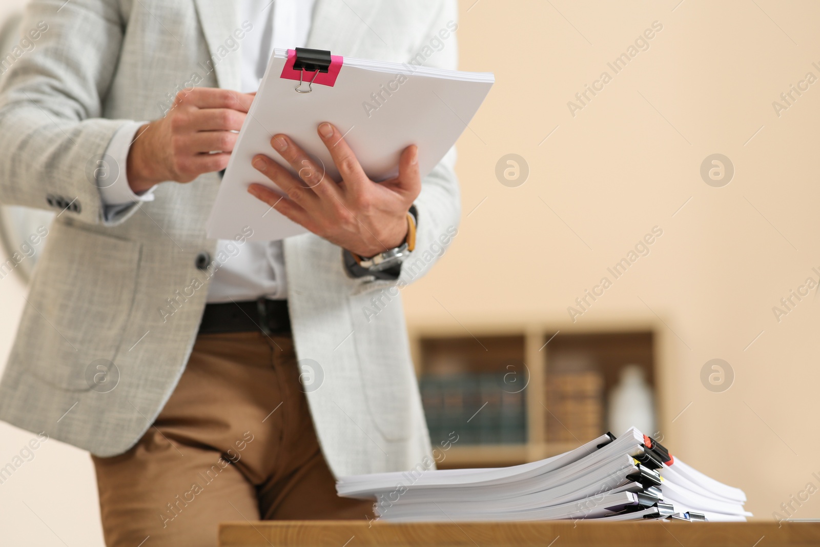 Photo of Man working with documents in office, closeup. Space for text