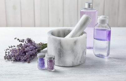 Composition with lavender flowers and natural cosmetic products on table