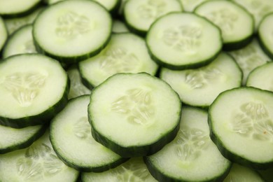 Fresh slices of cucumbers as background, closeup