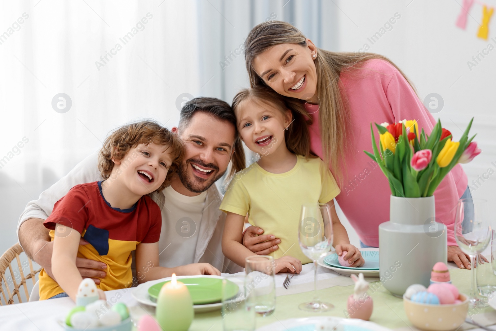 Photo of Easter celebration. Portrait of happy family at served table in room