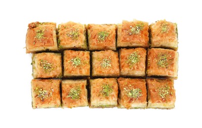 Photo of Delicious fresh baklava with chopped nuts isolated on white, top view. Eastern sweets