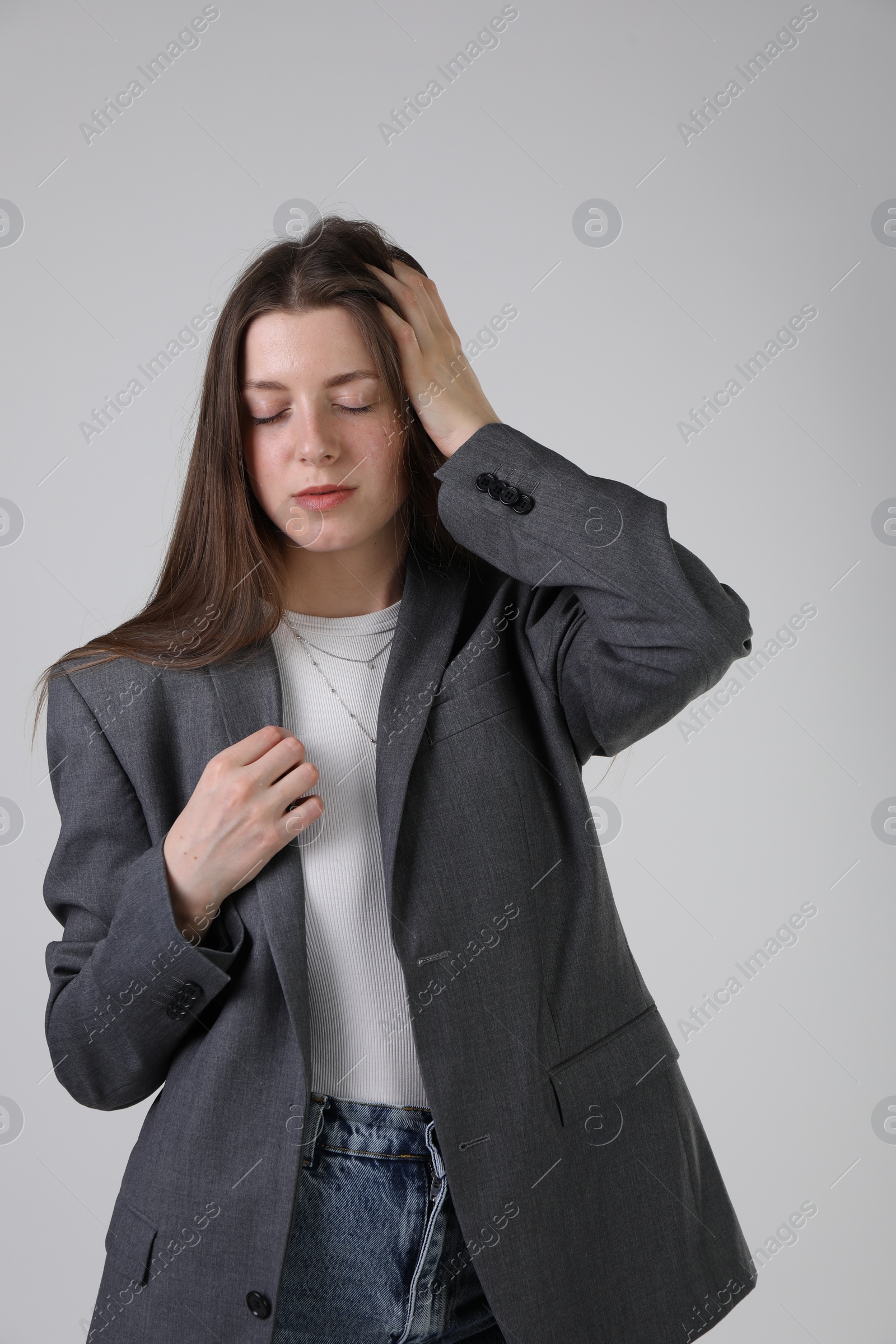 Photo of Portrait of beautiful young woman on light grey background