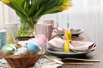 Festive table setting with napkin ring in shape of bunny ears, closeup. Easter celebration