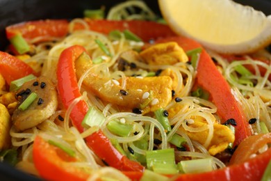 Photo of Stir-fry. Delicious cooked noodles with chicken and vegetables, closeup