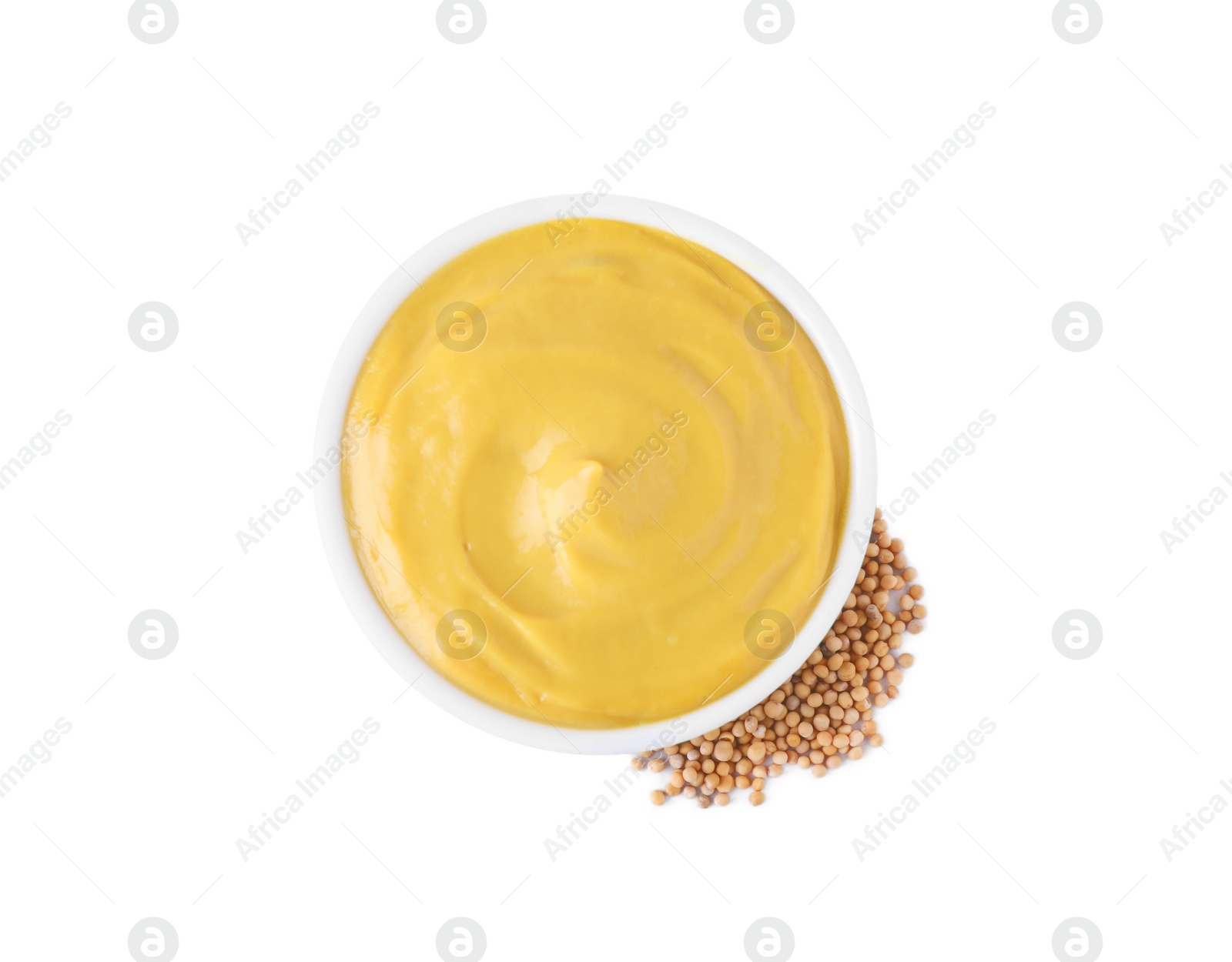 Photo of Bowl with delicious mustard and seeds on white background, top view