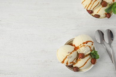 Photo of Flat lay composition with delicious ice cream on wooden table. Space for text