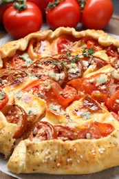 Photo of Tasty galette with tomato and cheese (Caprese galette) on table, closeup