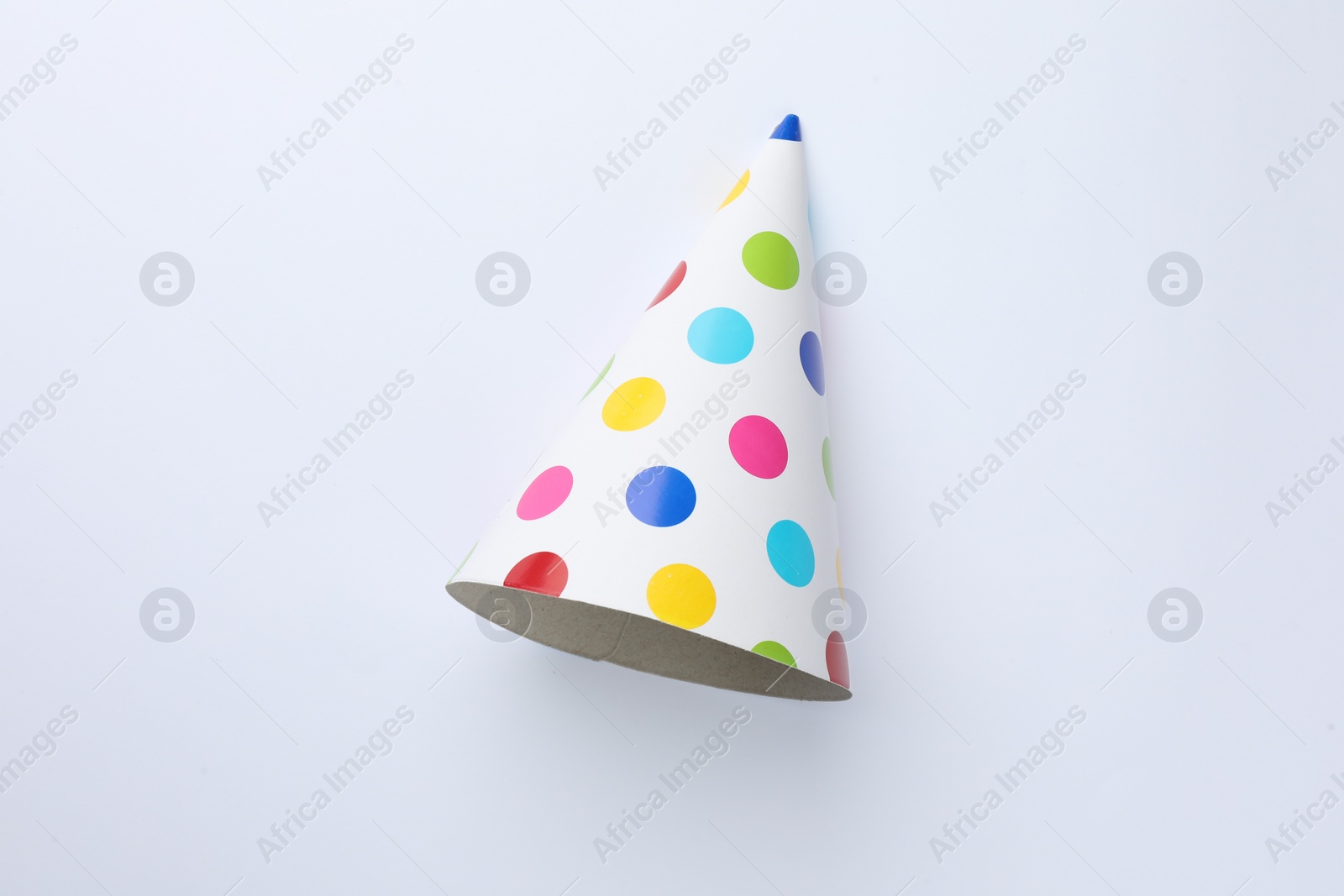 Photo of One beautiful party hat on light background, top view