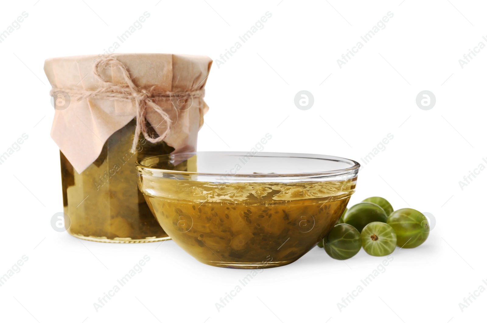Photo of Jar and bowl of delicious gooseberry jam, fresh berries on white background