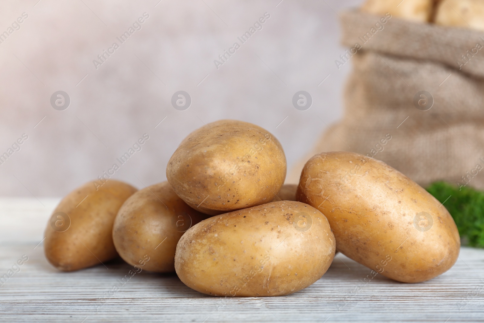 Photo of Fresh ripe organic potatoes on wooden table